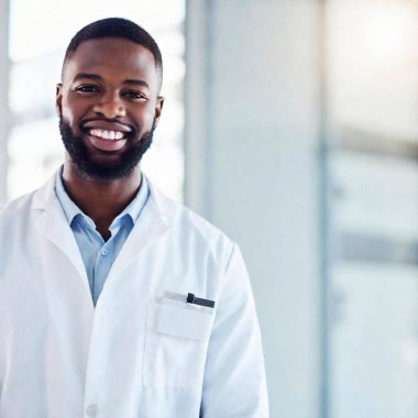 portrait of an african - american male doctor standing in front of a white background. clipart