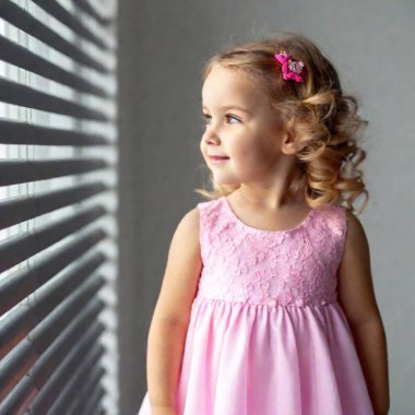 cute smiling little girl in a pink dress. clipart