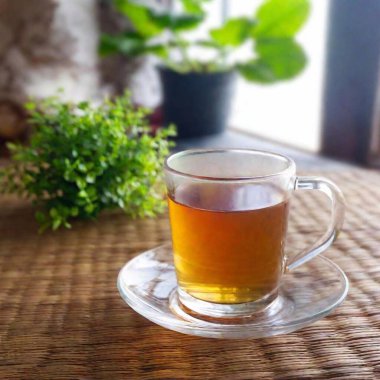 tea in a cup on a wooden background clipart