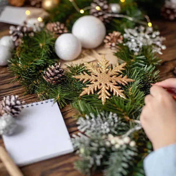 Hands Holding Christmas Decoration Wooden Table Fir Branches — Stock Photo, Image
