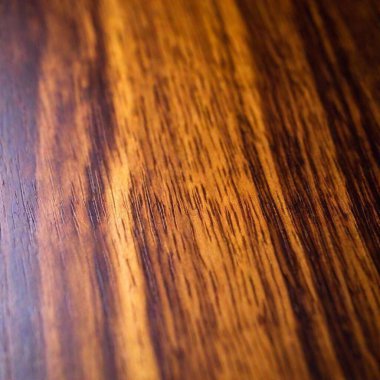 Polished Mahogany Surface: A close-up of a polished mahogany wood surface, in deep focus to highlight the smooth, glossy finish and the fine details of the wood grain. clipart