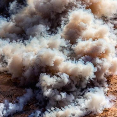 Close-Up of Smoke and Ash: A close-up photo of smoke and ash from an explosion, captured from eye level with deep focus to showcase the fine details and textures of the swirling smoke and residue. clipart