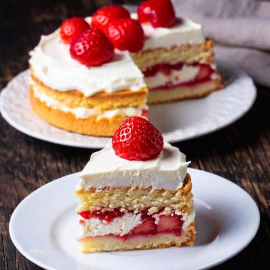 A close-up from above of a layered strawberry shortcake with fresh berries and whipped cream, with the cake in sharp focus and the background softly blurred, highlighting the dessert's freshness and details clipart