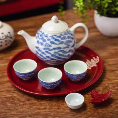 A Chinese restaurant with a traditional tea ceremony in progress, featuring elegant porcelain teapots and cups clipart