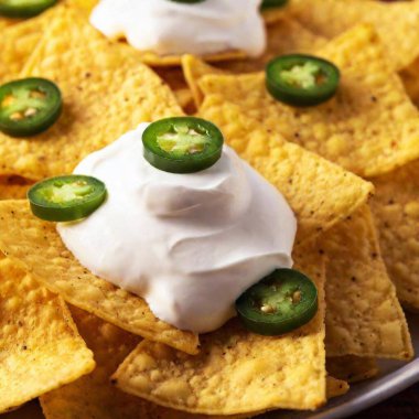 bowl of jalapeno jalapeno nachos, salsa and cheese dip clipart