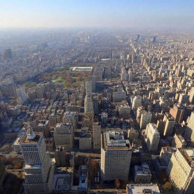 A high-resolution ultrarealistic image captures a dense and vibrant cityscape filled with a multitude of skyscrapers and buildings. Photographic in style, this aerial view showcases the architectural diversity within the urban landscape. Tall clipart