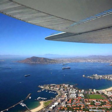 A high-resolution ultrarealistic image capturing an aerial view of Cape Town, South Africa. The photograph features a sweeping vista of the city, with the iconic Green Point Stadium prominently centered. Surrounding the stadium, lush green areas clipart