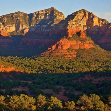 A high-resolution ultrarealistic image of Sedona, Arizona's iconic red rock formations captured during sunset. The digital photo showcases towering reddish-orange sandstone cliffs, illuminated by the warm golden light of the setting sun. The rich clipart