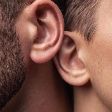 A high-resolution ultrarealistic image capturing an intimate moment of communication, rendered in a photographic style. On the left, a close-up view of an ear with a hand cupped around it, suggesting someone is listening intently. On the right clipart