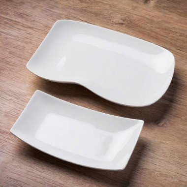 A high-resolution ultrarealistic image featuring a set of four pristine, white ceramic plates, each shown from a different angle. The first plate is displayed from the top view, revealing its smooth, gently sloping surface. The second plate is seen clipart