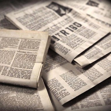 A high-resolution ultrarealistic image depicting a scatter of vintage newspapers in black and white text spread randomly on a flat surface. The newspapers feature various articles, columns, and headlines in a serif typeface, giving an authentic old clipart