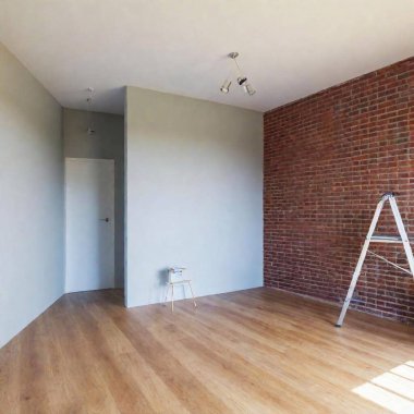 A high-resolution ultrarealistic image depicting an unfinished renovation project in a modern living space. The digital photograph captures a room with a partially exposed brick wall on the left, showcasing a ladder against it and a few construction clipart