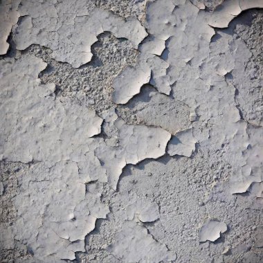 A high-resolution photograph of a textured concrete wall. The image captures the rugged, gritty surface of the wall, showcasing various shades of gray with subtle gradients. The texture is detailed, revealing small cracks, scratches, and flecks that clipart