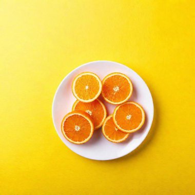 fresh orange cut into segments, arranged on a white plate with a clean, minimalist background, showcasing the vibrant colors and juicy texture clipart