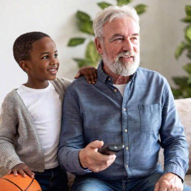 portrait of happy father and son playing video games on smartphone clipart