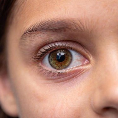 Extreme close-up of a child's eye, reflecting the colors of the National Day parade happening nearby clipart