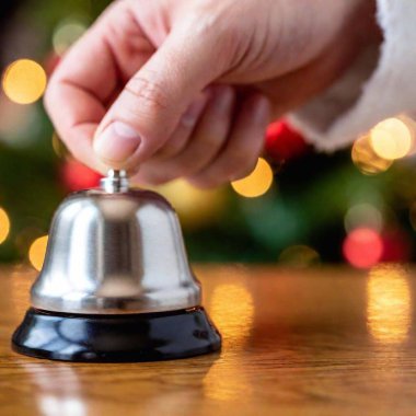 Macro shot of Santa's sleigh bell ringing in his hand  clipart