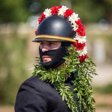 A close-up of a jockey's helmet adorned with victory flowers, capturing the essence of celebration clipart