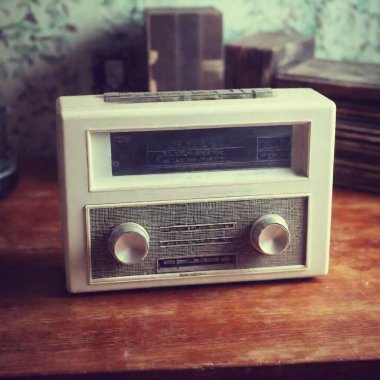 A close-up of a vintage cassette player on a cluttered desk, styled like an 80s film photograph, with heavy grain, dust specks, and scratches giving it an aged appearance clipart