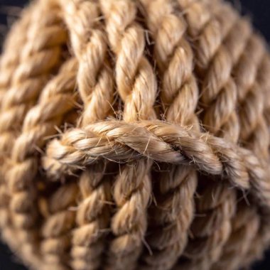 Extreme macro of a frayed rope, showing the intertwined fibers unraveling. clipart