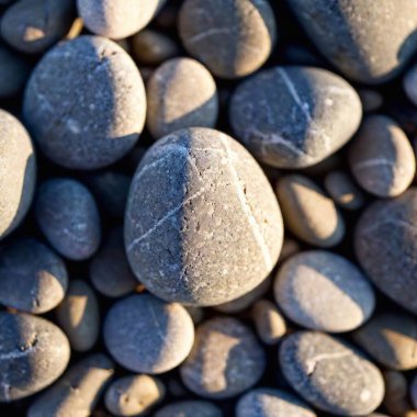 Extreme macro of a pebble on a beach, showing the smooth texture and tiny imperfections. clipart