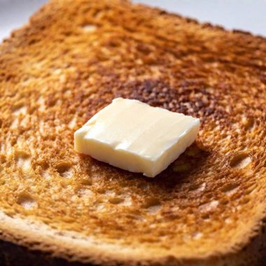 Macro shot of butter melting on warm toast clipart