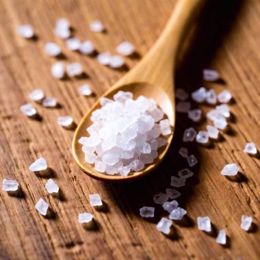 Close-up of the granules of sea salt on a wooden board. clipart