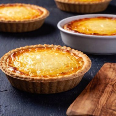 Close-up of macaroni pie with a dark background, the white plate showcasing the golden pasta and cheesy layers in vivid detail, giving an inviting view of each macaroni piece clipart