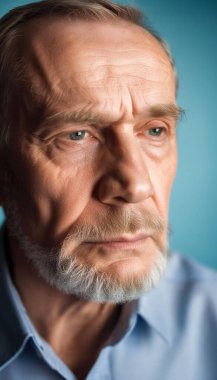 Extreme close-up portrait of an elderly man with a solemn look, slightly holding his head as if experiencing discomfort or pain, against a soft blue background. clipart