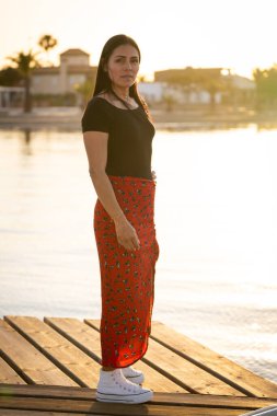 girl at sunset on the pier clipart