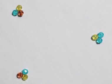 Colorful beads with white background. Place for text.