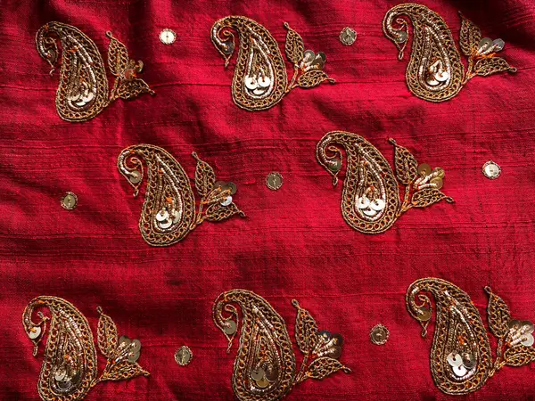 stock image Intricate marodi hand embroidered paisley motifs all over red raw silk