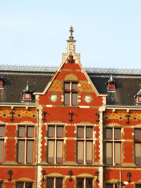 Amsterdam tren istasyonu binası. Mavi gökyüzü altında eşsiz mimari tasarımı var.