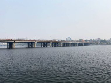 The Ellis Bridge, an iconic landmark in Ahmedabad, stands gracefully over the Sabarmati River, showcasing a blend of historic charm and modern development. clipart