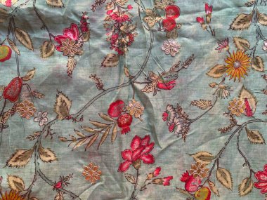 Klasik bir çiçek deseni mavi krep kumaşını süslüyor, narin pembe çiçeklerle, sonsuz bir cazibe katıyor..