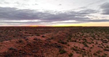 4Kserene 'deki Simpson Çölü üzerindeki nefes kesici günbatımını ve ufukta güneş batarken Avustralya ikonik çölünün genişleyen manzarasını deneyimleyin. Gökyüzünü turuncu ve mor renklerle boyayın.. 