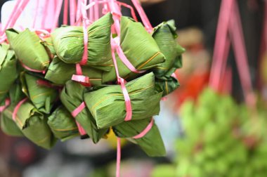 Alkaline rice dumplings, a Dragon Boat Festival delicacy, are made from glutinous rice and alkaline water, featuring a chewy texture and often filled with sweet red bean or date paste. clipart