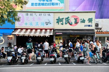 Taiwan - Aug 03, 2024: Experience Jiaoxi's top culinary delights with Wu's Peanut Roll Ice Cream and Ko's Scallion Pancakes, beloved by locals and a must-visit for tourists in Yilan. clipart