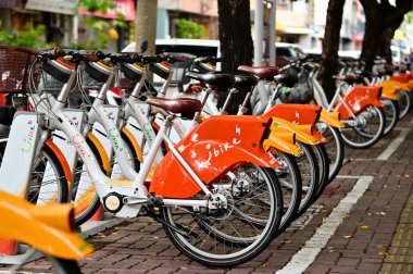 Tayvan - 08 Temmuz 2024: YouBike 2.0E 'yi keşfedin, turuncu renkli canlı tasarım ve elektrik destekli, geleneksel modellere kıyasla kamu bisikletinin kolaylığını artıran.