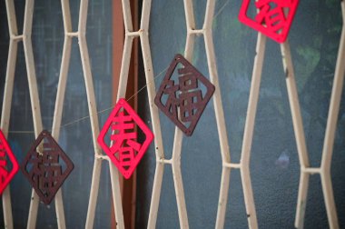 During Lunar New Year, traditional decorations such as spring couplets and window flowers are essential. These festive symbols, with words like 