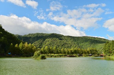 Yilan 'ın Yuanshan kasabasında yuva yapmış olan Wanglongpi, mavi gökyüzünün altında parıldıyor. Kristal berraklığındaki göl, yeşil dağları yemyeşil eder. Huzurlu ve görkemli bir manzara yaratır..