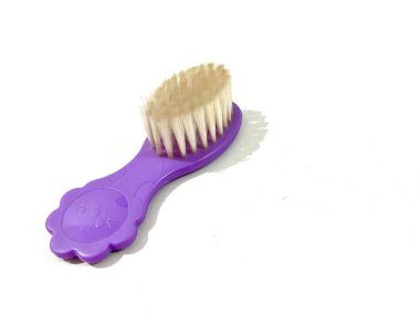 Yumuşak tüylü bebek tarak fırçası ve beyaz arka planda izole edilmiş mor saplı