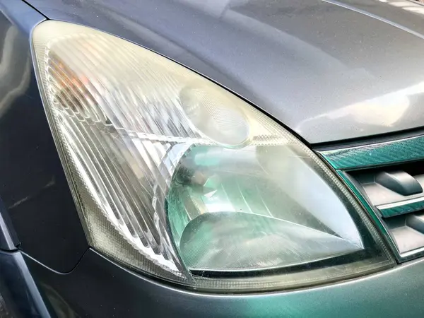 stock image Close up view of dirty car headlight with hazy and unpolished glass