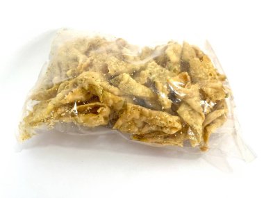 Beyaz arka planda izole edilmiş plastik bir torbada kızarmış wonton cipsi ya da Pangsit Goreng. Çıtır çıtır ve baharatlı Asya atıştırmalıkları çorba, erişte ve salata için mükemmel..