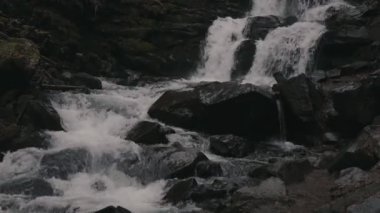 Landscape of waterfall Shypit in the Ukrainian Carpathian Mountains. The water flows beautifully over the rocks. Mountain river. Beautiful big waterfall in the mountains.