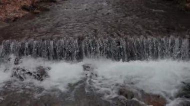 The water flows beautifully over the rocks. Mountain river. Beautiful little waterfalls. Beautiful streams and small waterfalls near the big Carpathian waterfall Shypit.
