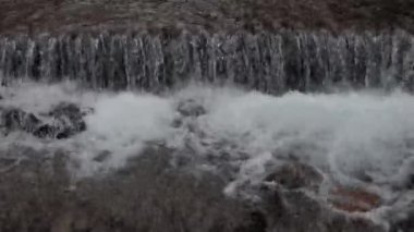 The water flows beautifully over the rocks. Mountain river. Beautiful little waterfalls. Beautiful streams and small waterfalls near the big Carpathian waterfall Shypit.