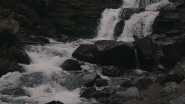 Landscape of waterfall Shypit in the Ukrainian Carpathian Mountains. The water flows beautifully over the rocks. Mountain river. Beautiful big waterfall in the mountains.