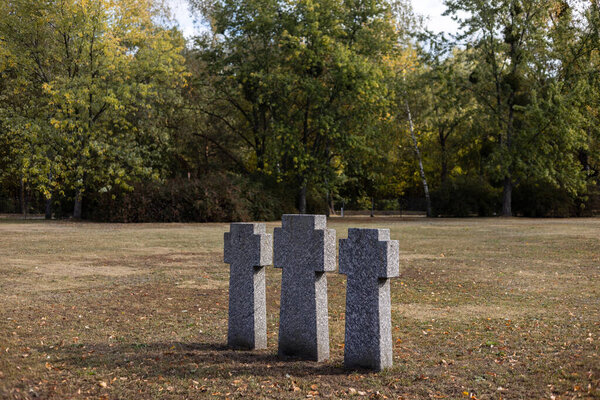 Stone tombstones in the German cemetery in the fall. Beautiful German cemetery near Kyiv. Many dead German soldiers of the dead during the 2nd World War.
