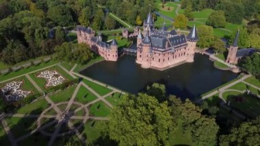 Hollanda 'nın en büyük şatosunun manzarası, De Haar. Şatonun, parkın ve kalenin etrafındaki su hendeğinin üzerinde güzel bir kuadkopter uçuşu. İngiliz tarzında güzel bir park..